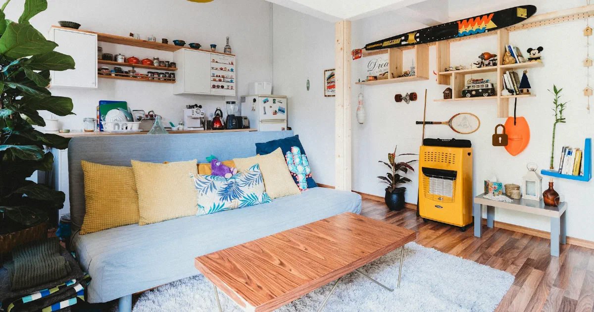 Bright, open living room with a sofa, shelves, and a coffee table
