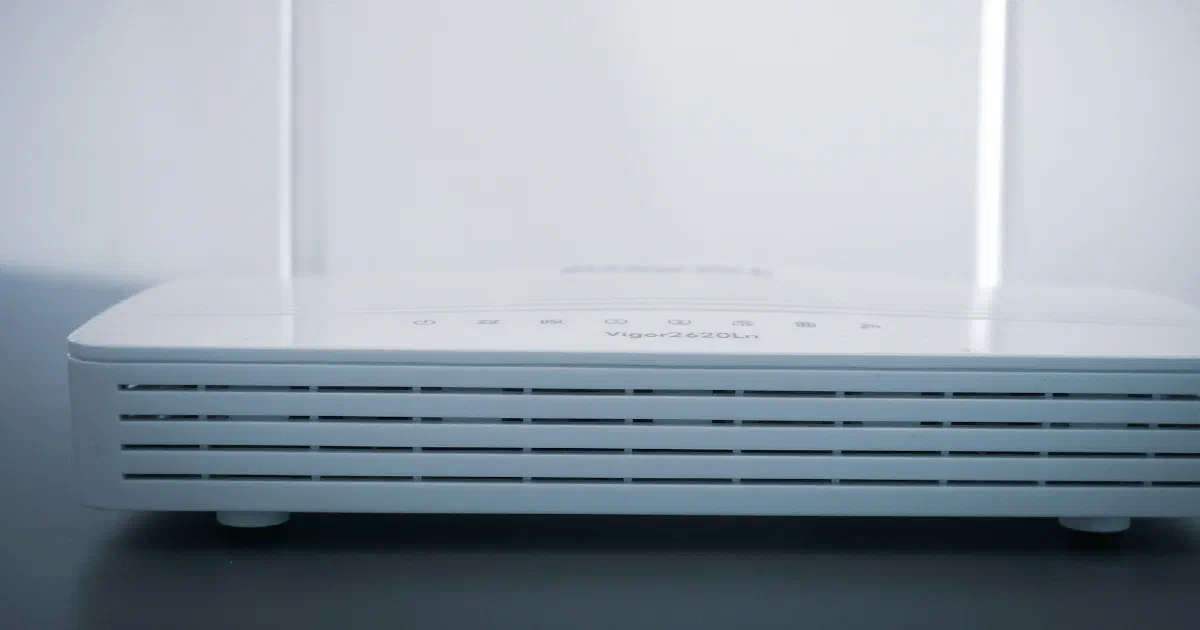 White Wi-Fi router with two antennas against a bright background
