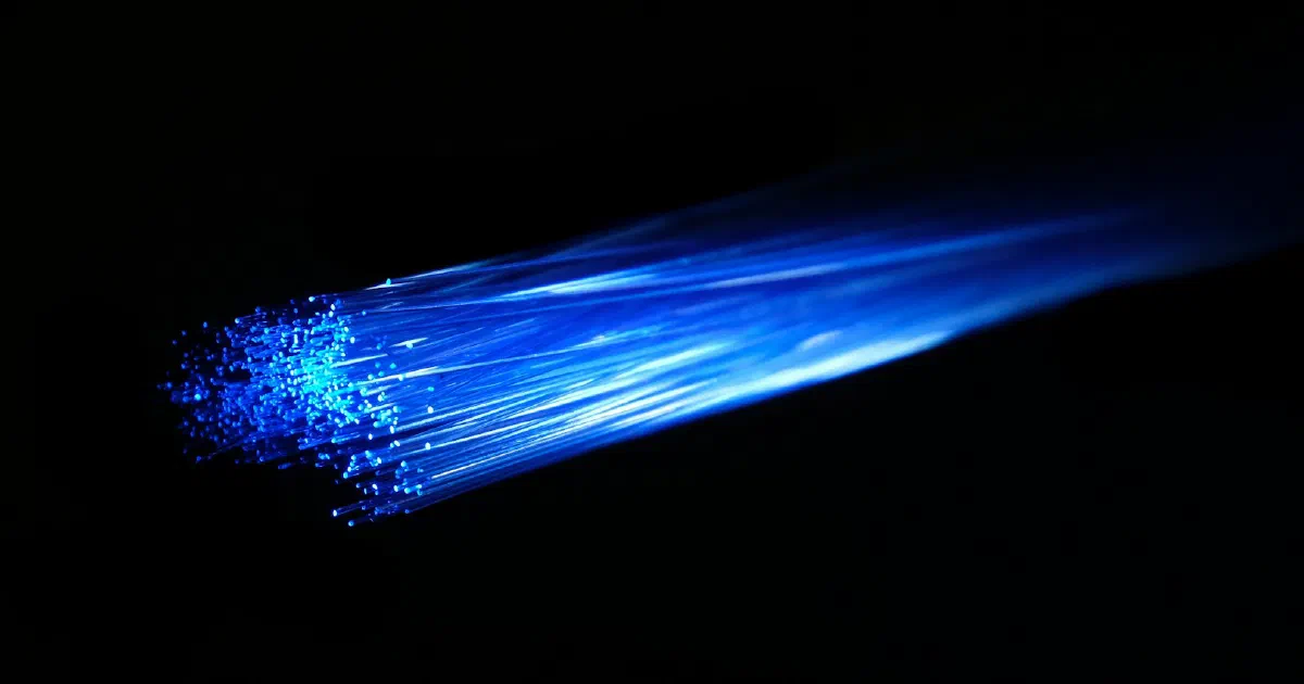 Ends of fiber-optic strands glowing blue in the dark
