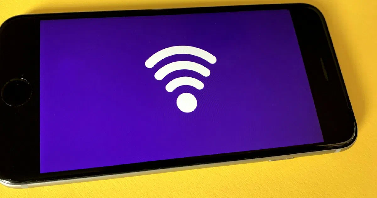 Smartphone showing a Wi-Fi symbol on a yellow background