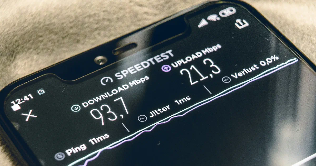 Phone screen showing speed test results for download, upload, and ping