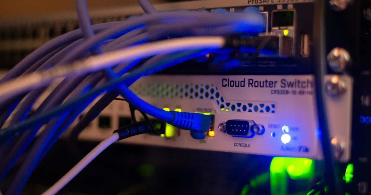 Network router with blue Ethernet cables plugged in and status lights on