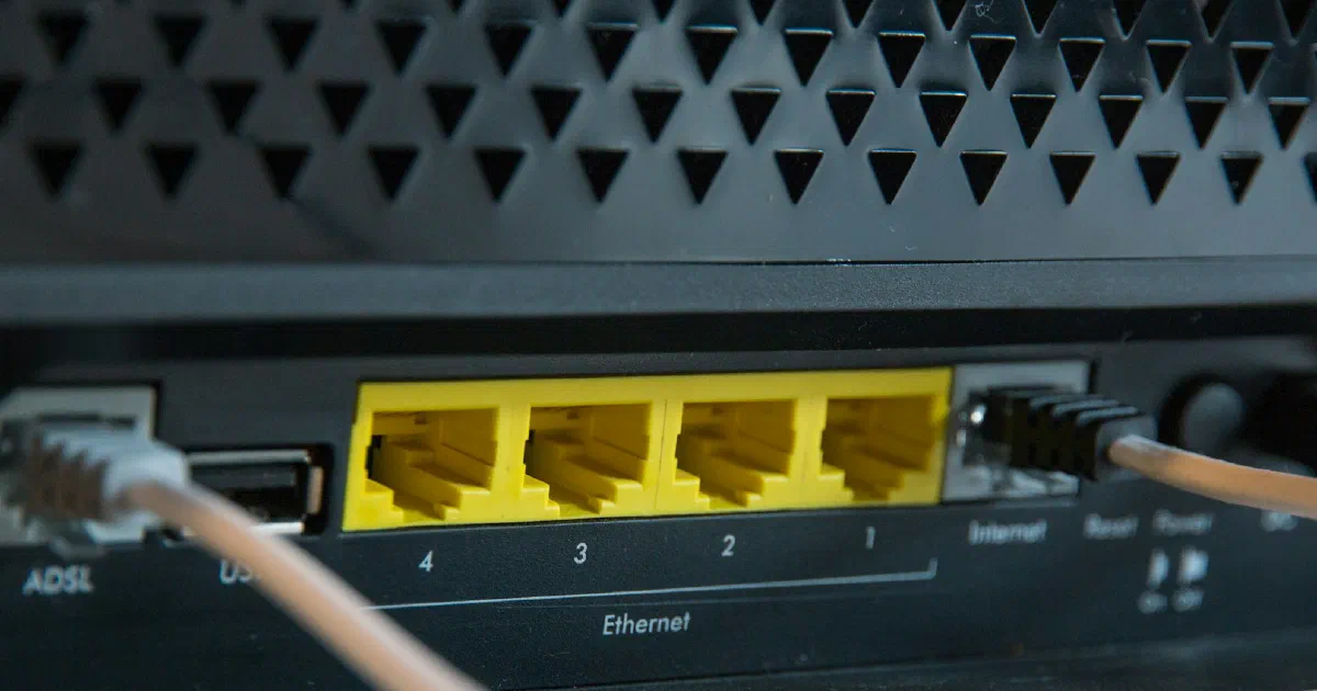 Ethernet cables plugged into the yellow LAN ports on the back of a router